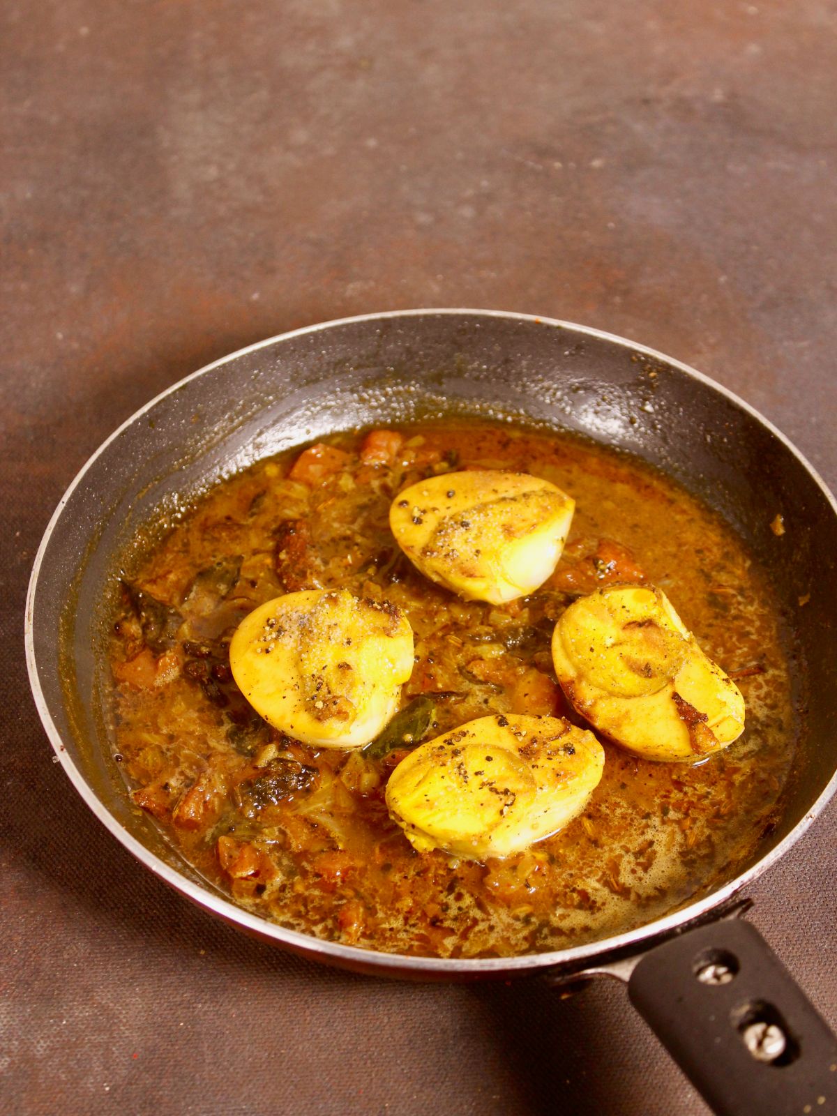 add fried eggs to the gravy and cook  