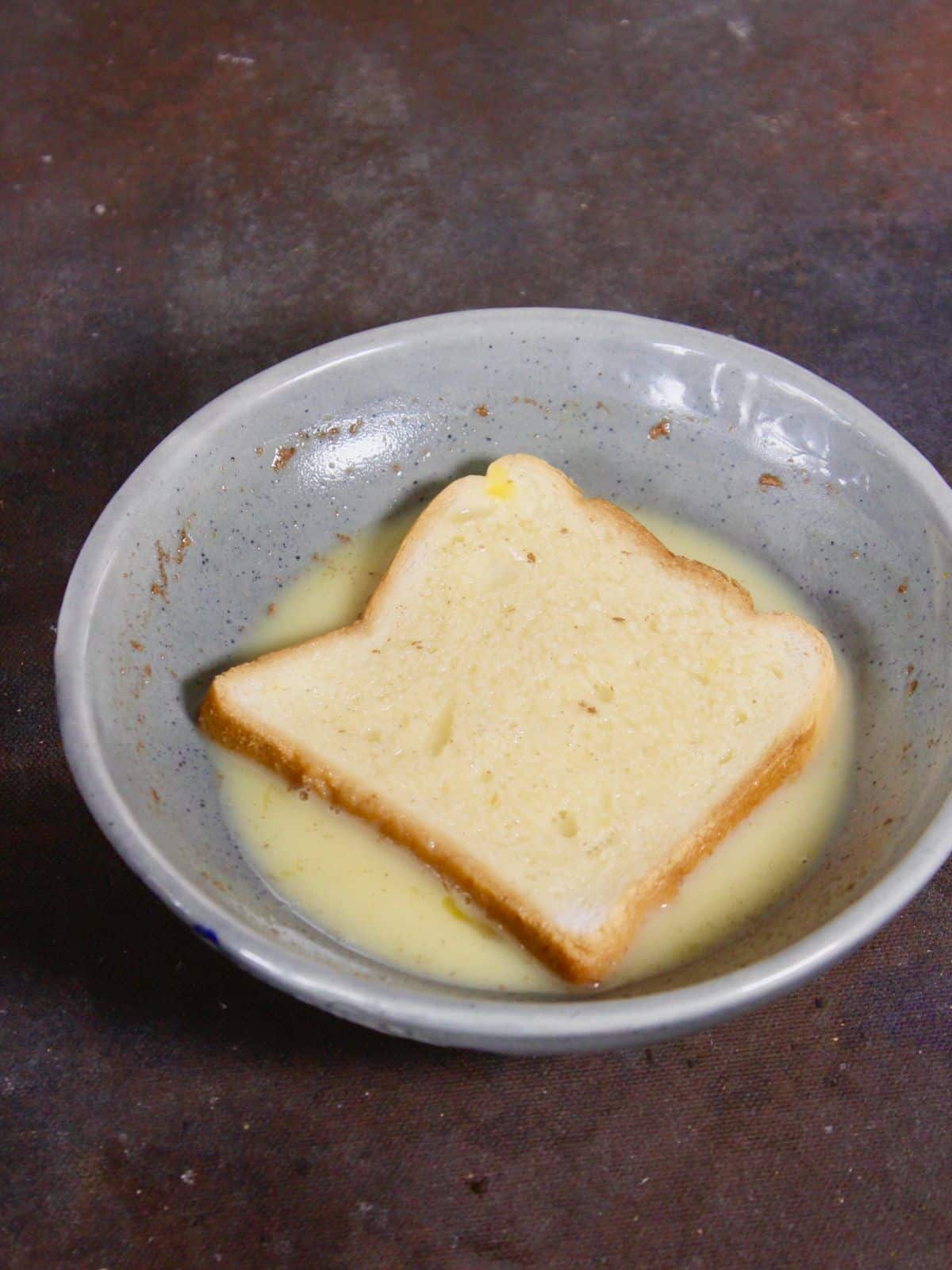 dip the bread slice into it on both the sides 