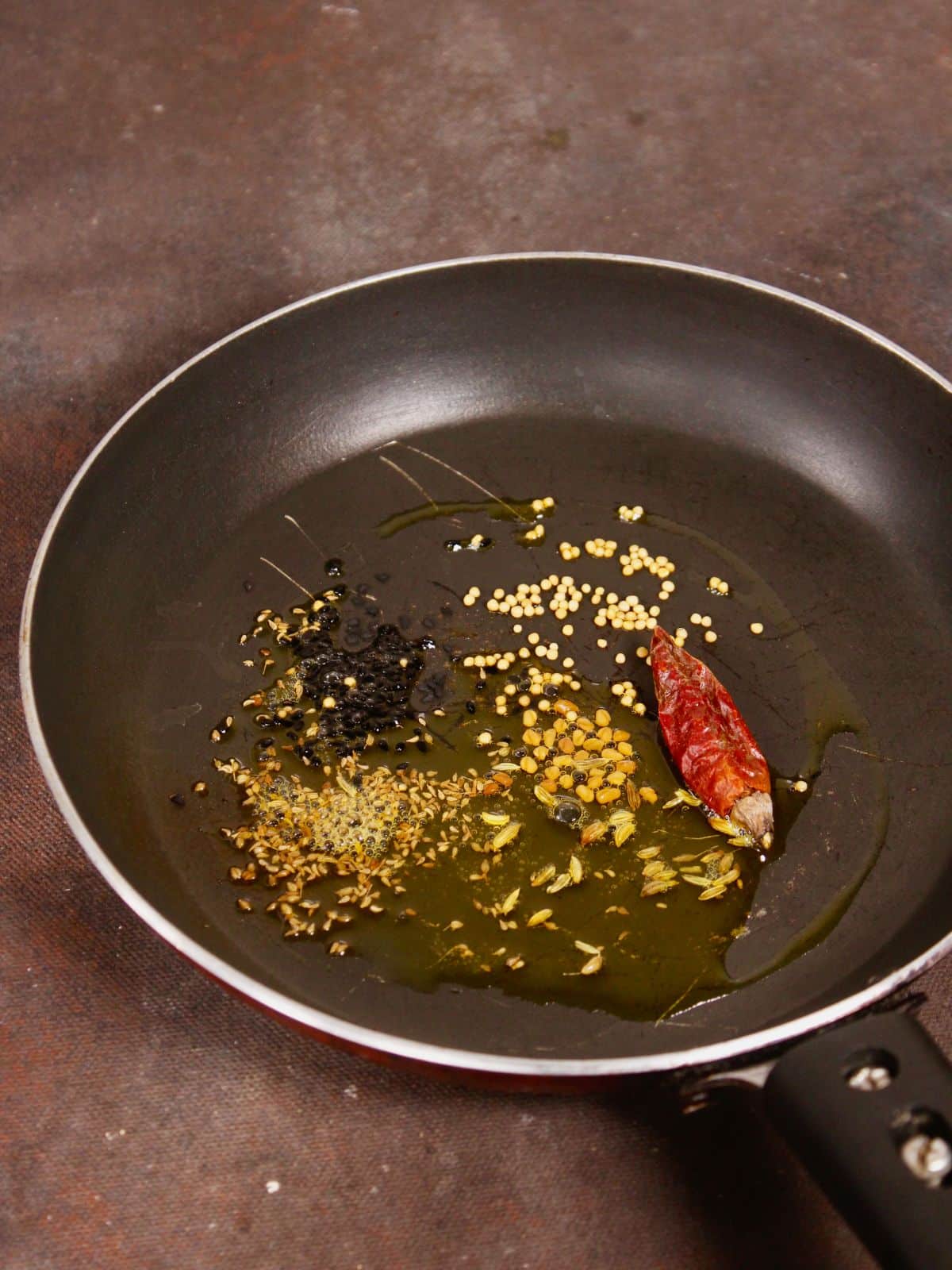 take whole spices along with oil in the pan and saute 