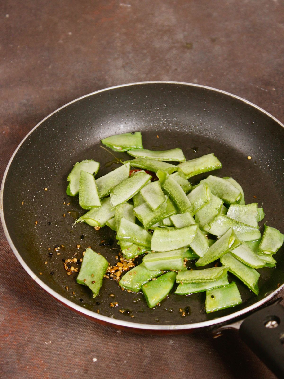 add broad beans to the pan and saute 