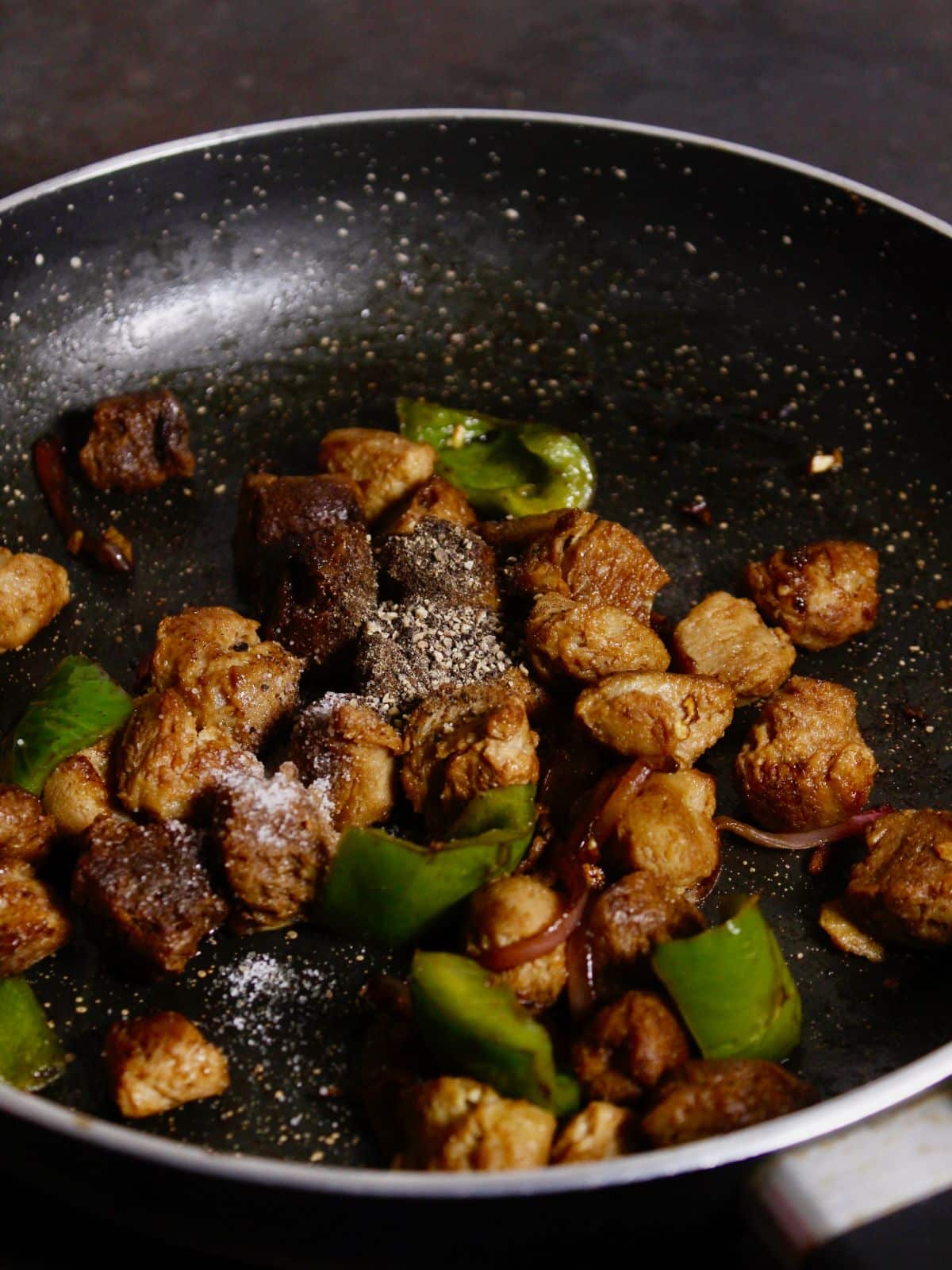 add soya sauce and powdered spices to the pan and mix well 