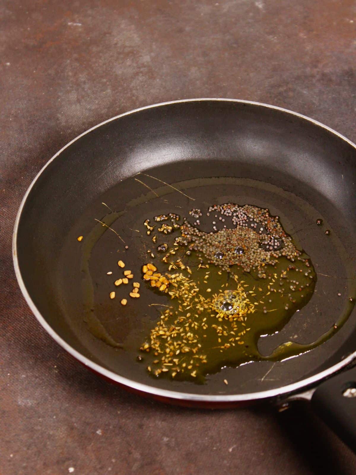 add seeds with oil in a pan and saute 