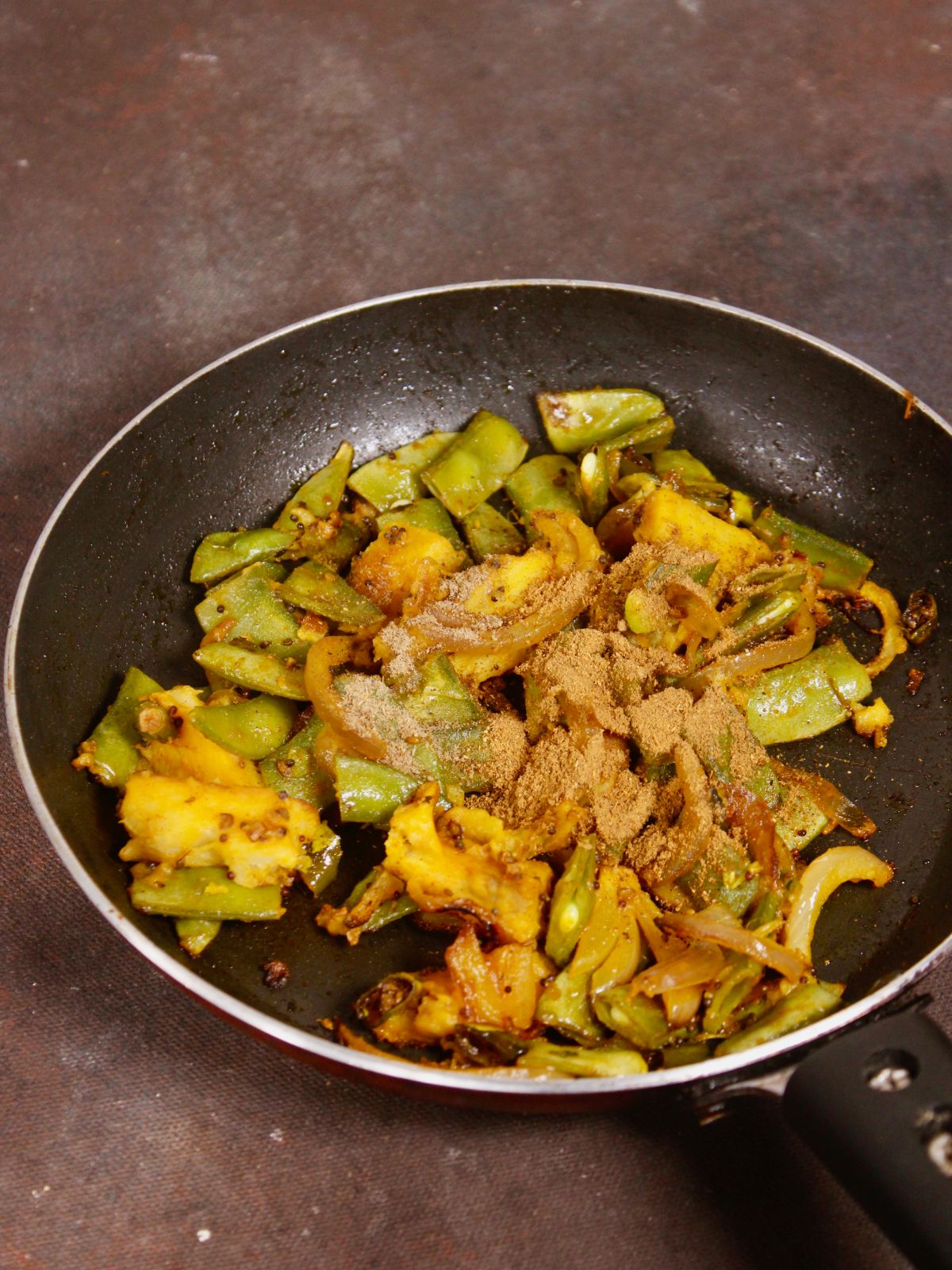 add cumin powder and chopped coriander to the pan and mix well