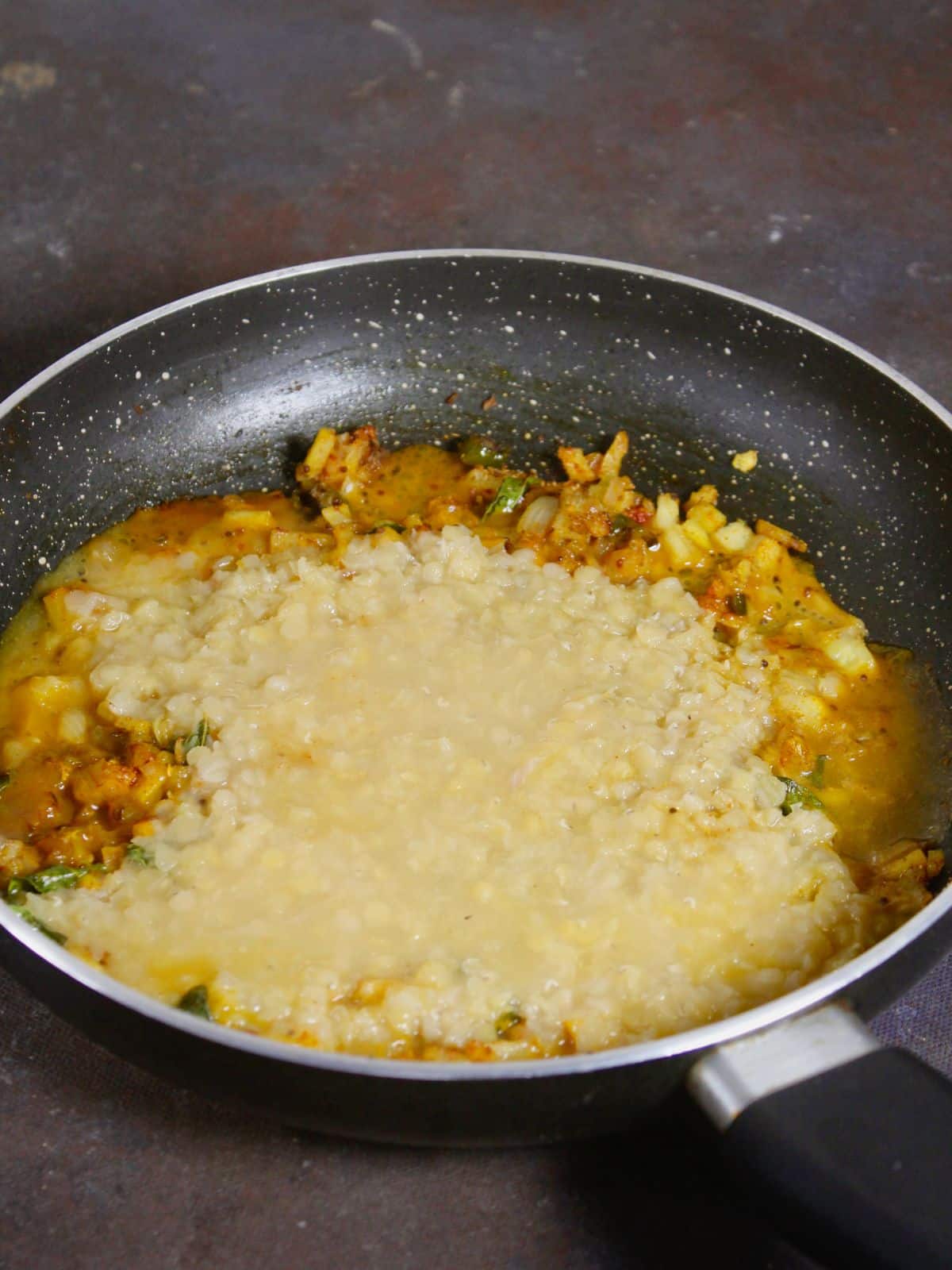 add boiled red lentils to the pan and mix well