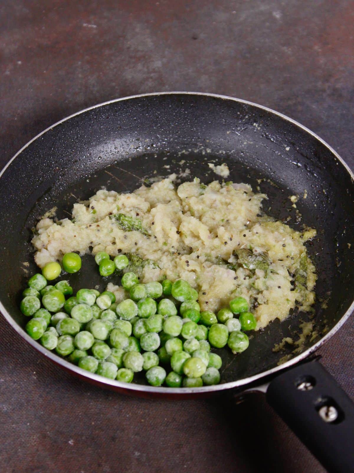 add peas to the pan and mix well 