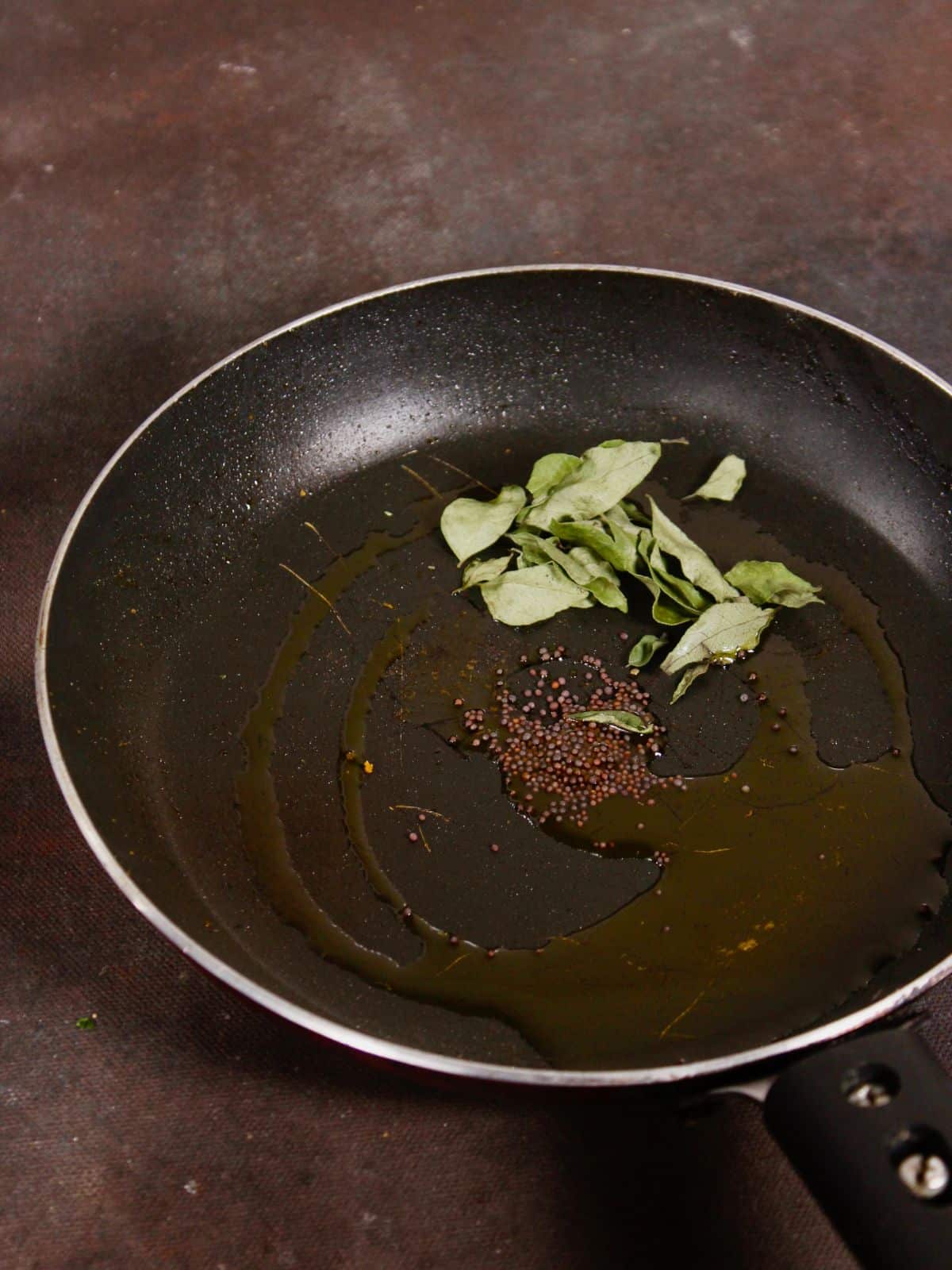 add seeds and curry leaves with oil in a pan 