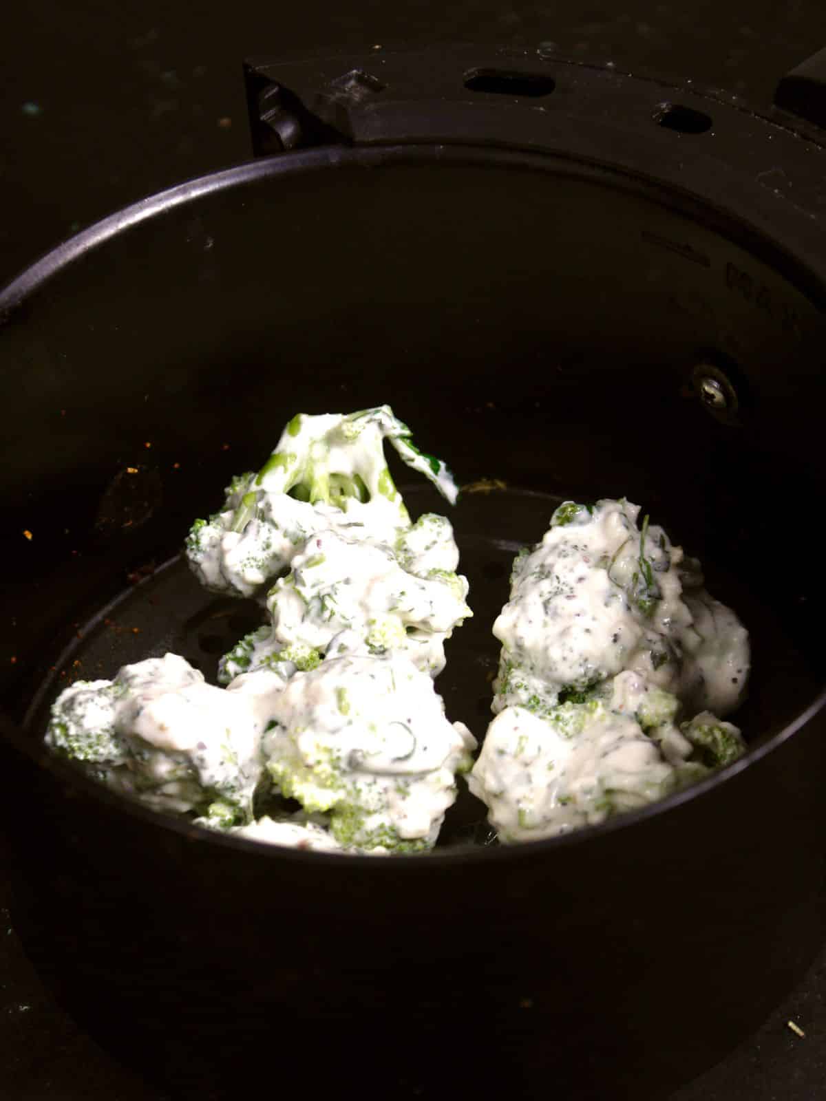 transfer marinated broccoli into the air fryer 