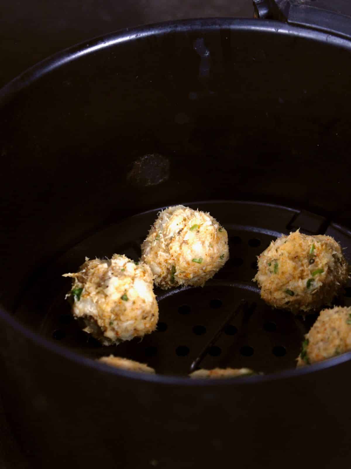 small balls made out of mash transferred into an air fryer