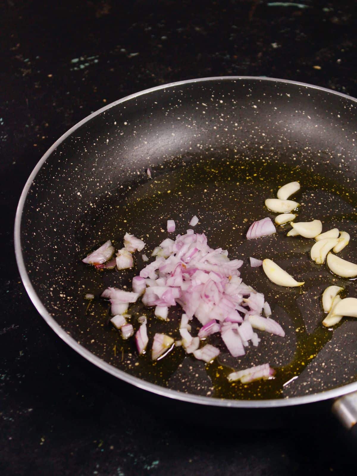 chopped onions and garlic in a pan  