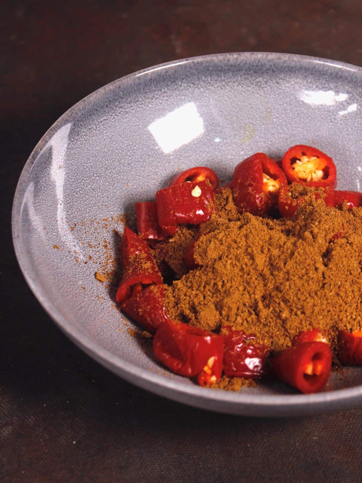 add seeds powder with chili in a bowl 