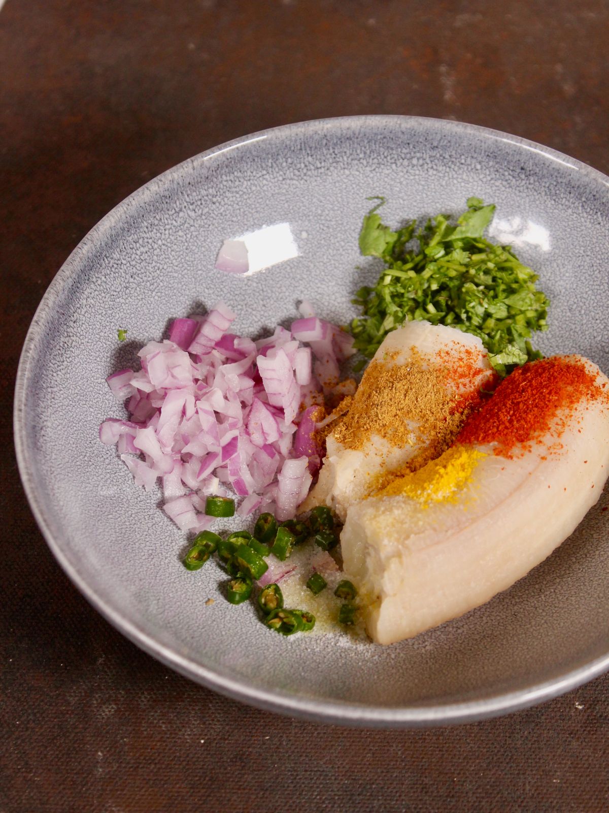 take all the ingredients for raw banana fritters in a bowl 