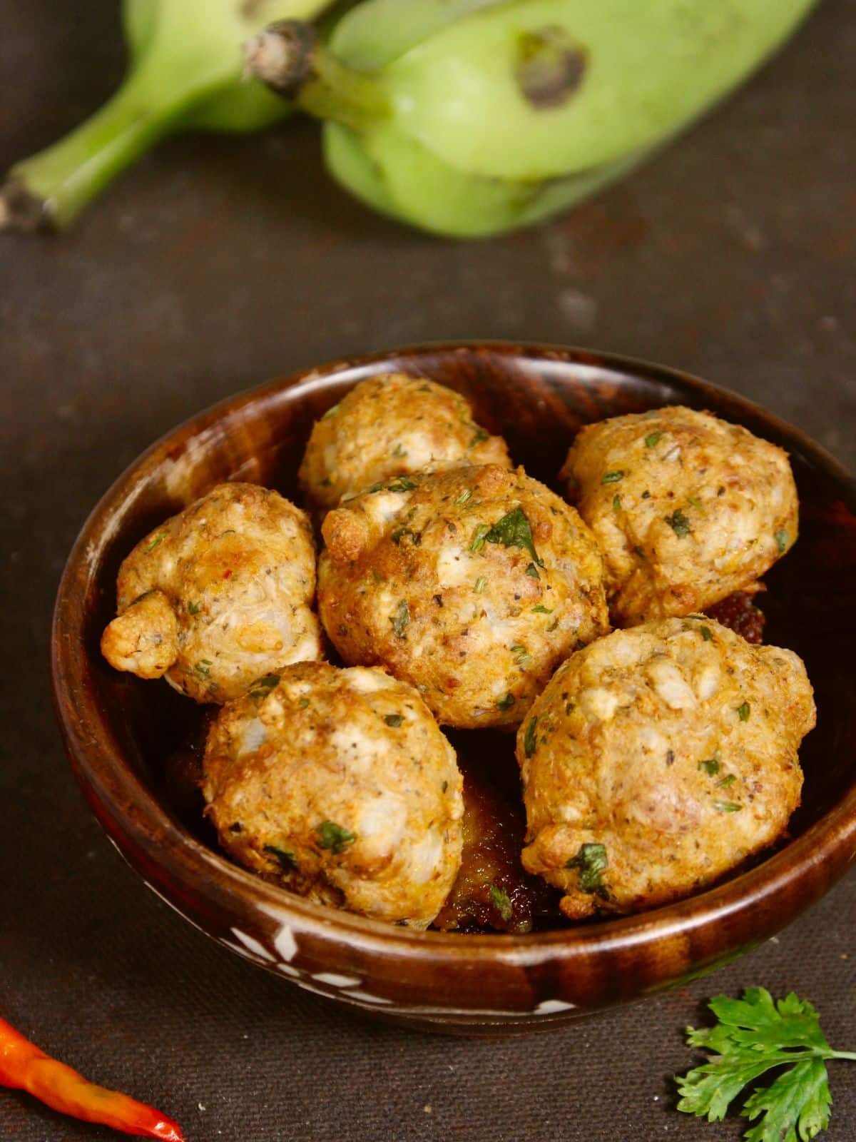 enjoy raw banana fritters balls with tea 