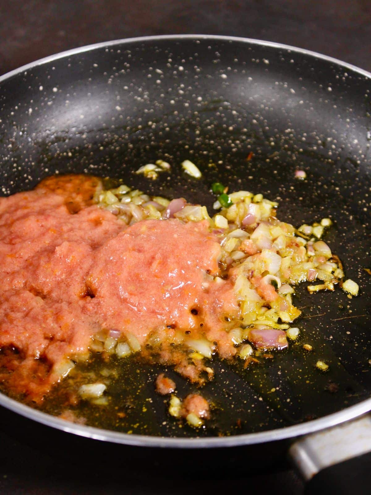 add tomato paste to the pan and mix well 