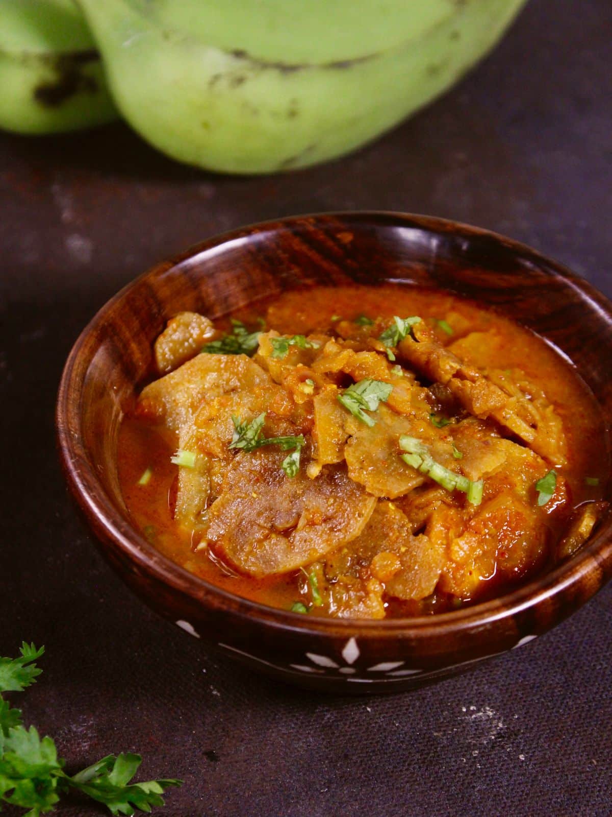 serve delicious raw banana chips curry in a bowl with some chapati  