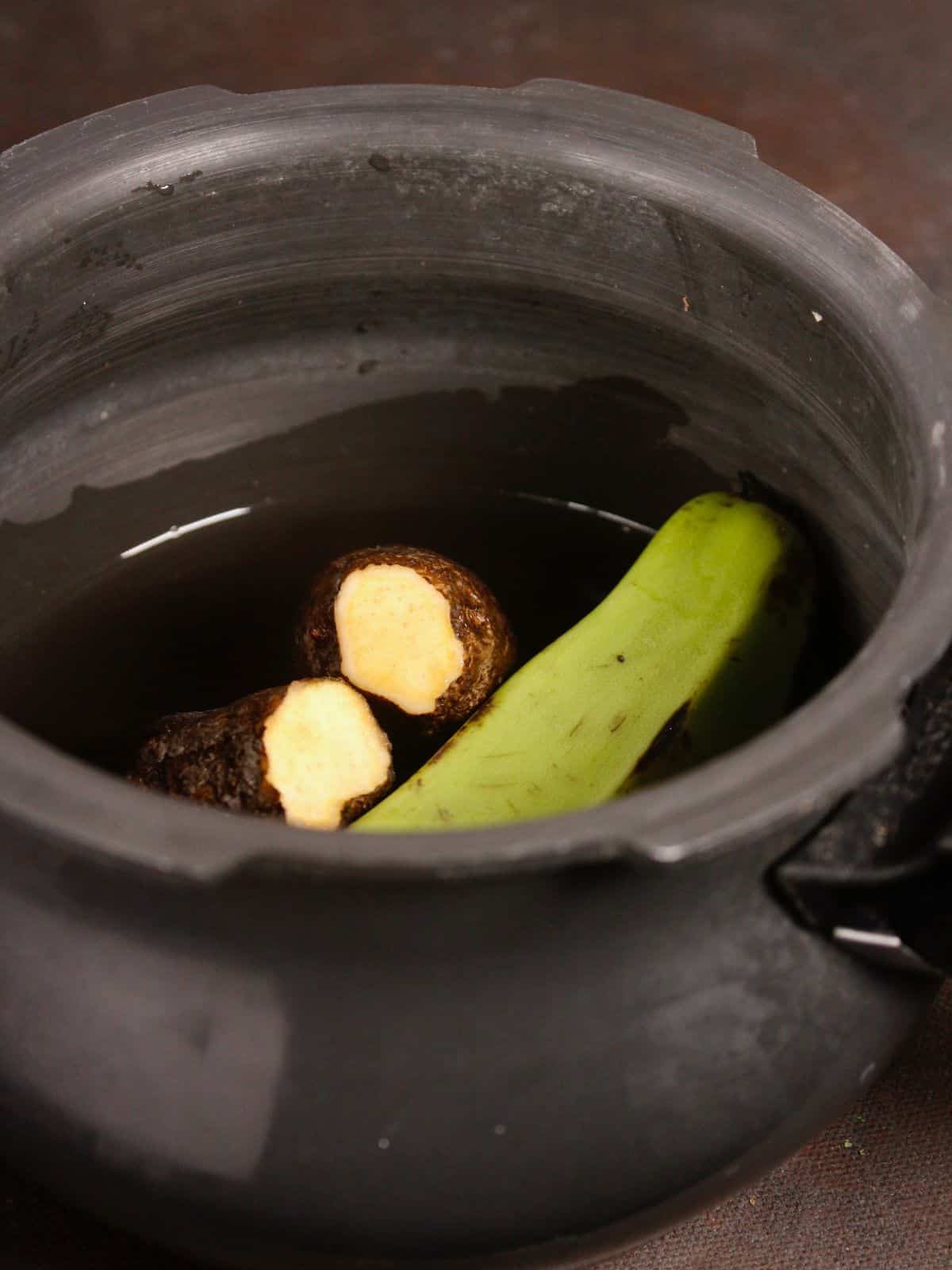 boil raw banana and yam in a cooker 
