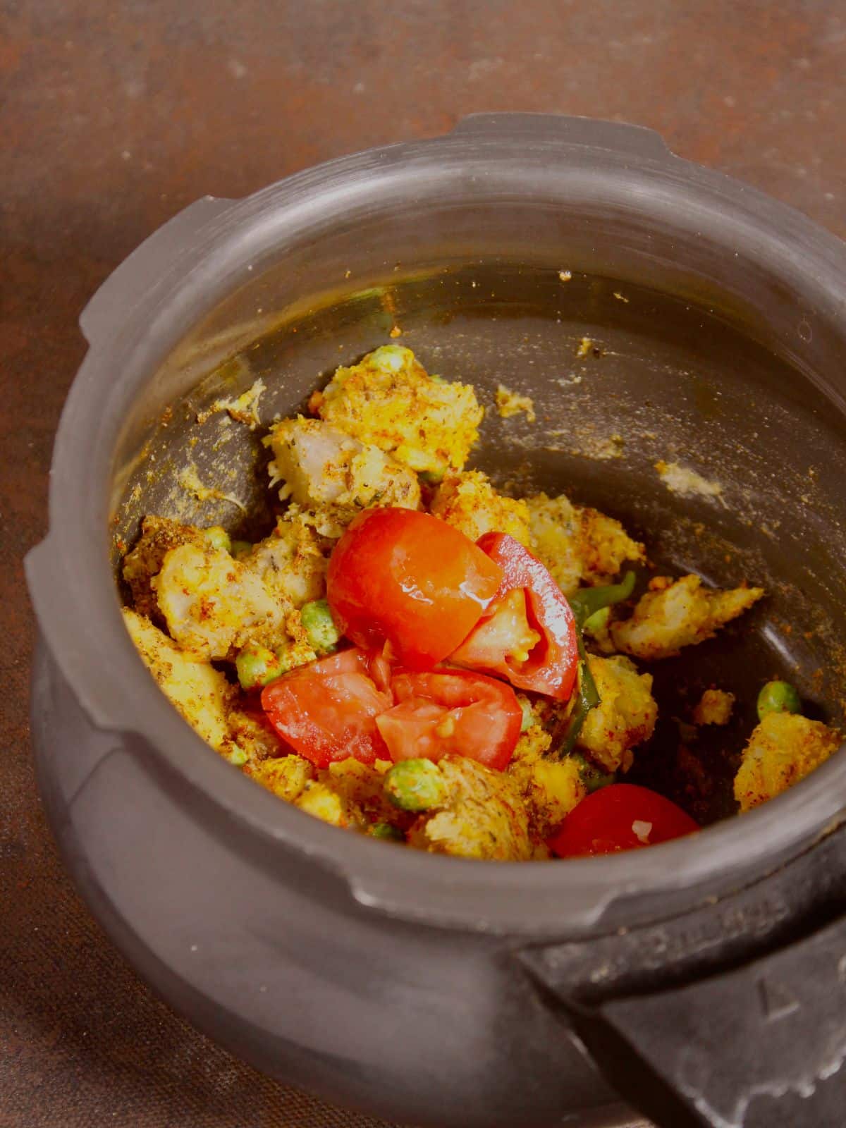 add chopped tomatoes and water to the pot and cook 