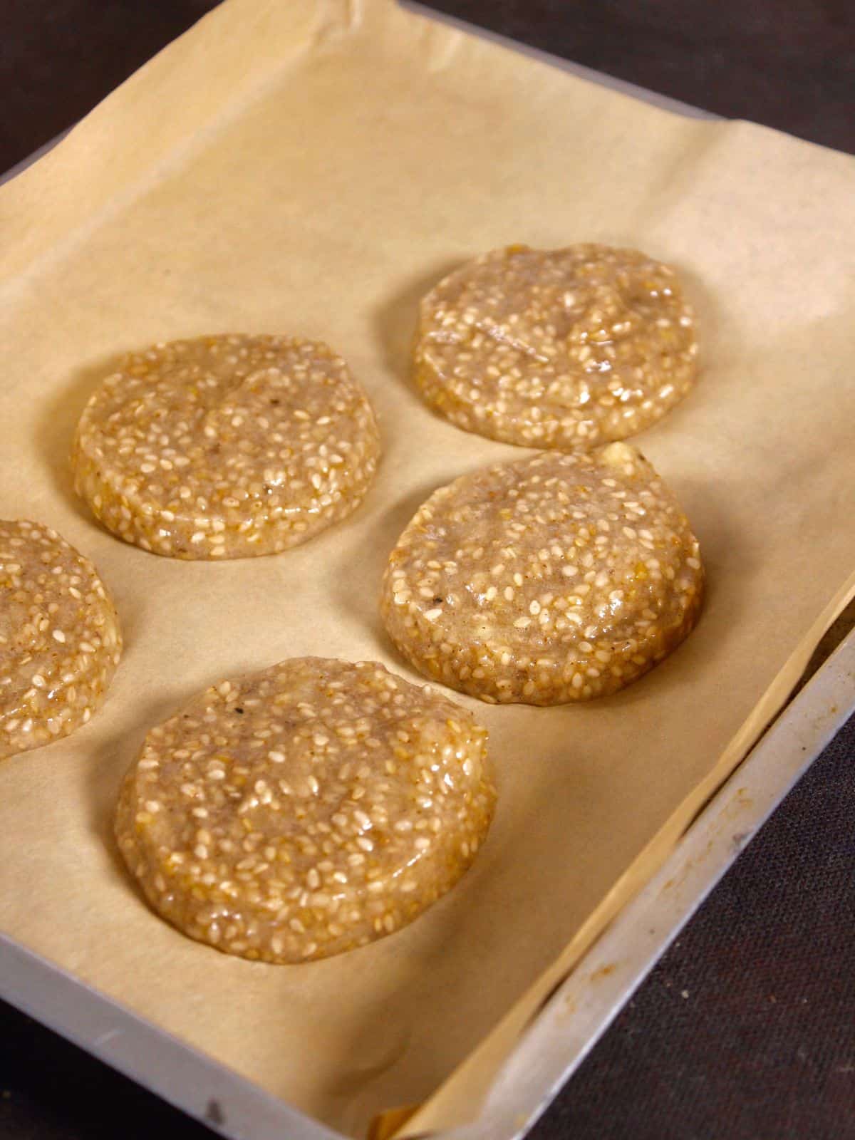 transfer the paste onto parchment paper in small small flat balls form