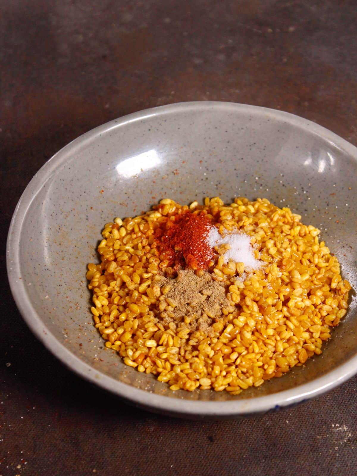 transfer the fried dal into the bowl and mix powdered spices and mix well 