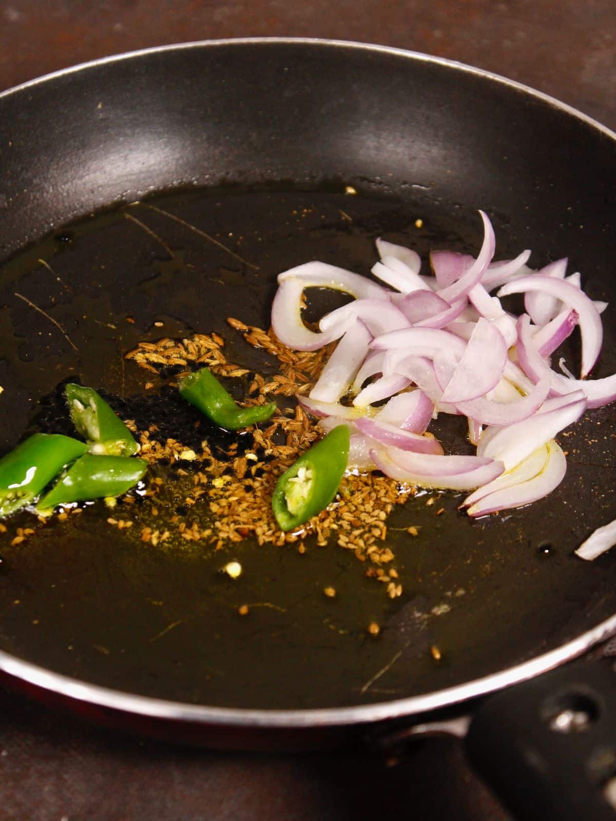 add chopped onions and green chilies 