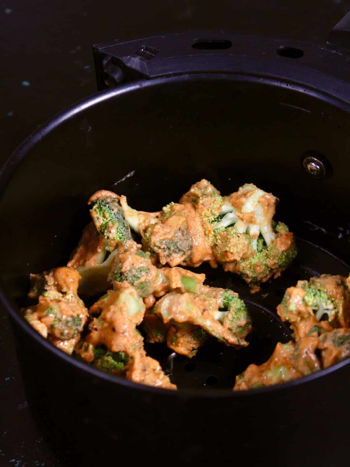 transfer the coated broccoli florets into an air fryer 