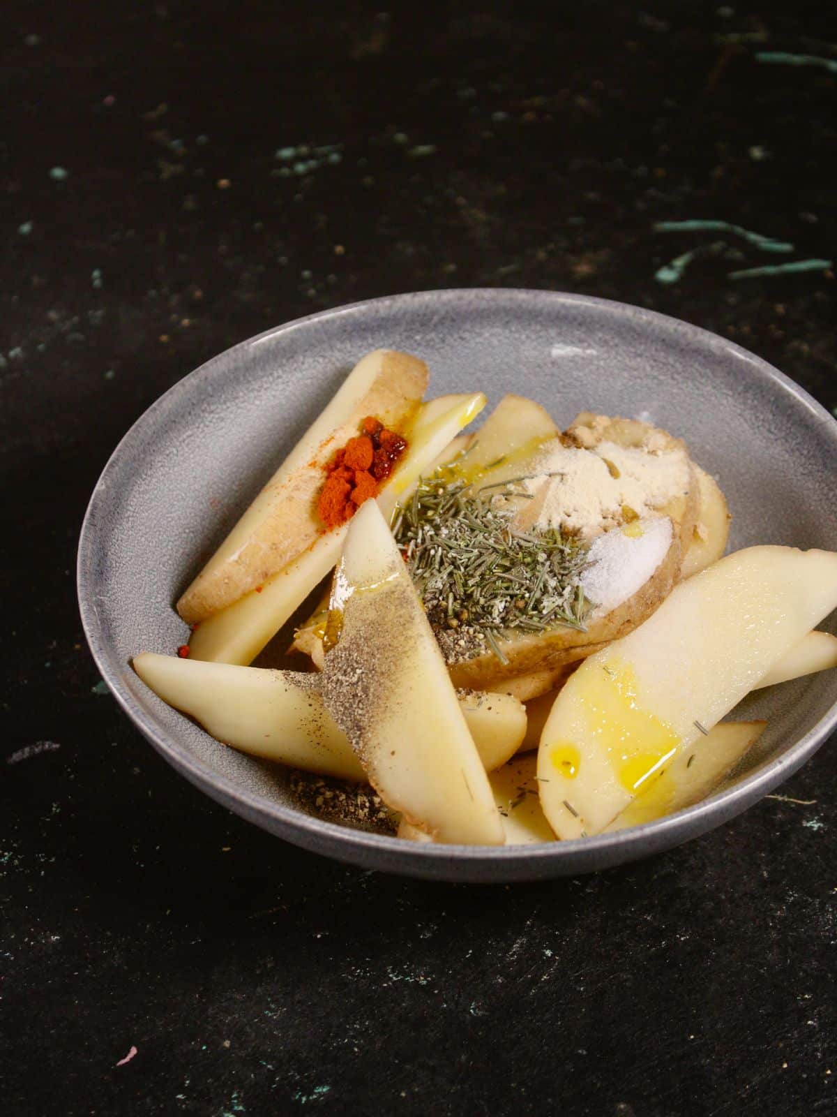 potato wedges with all the other ingredients in a bowl 