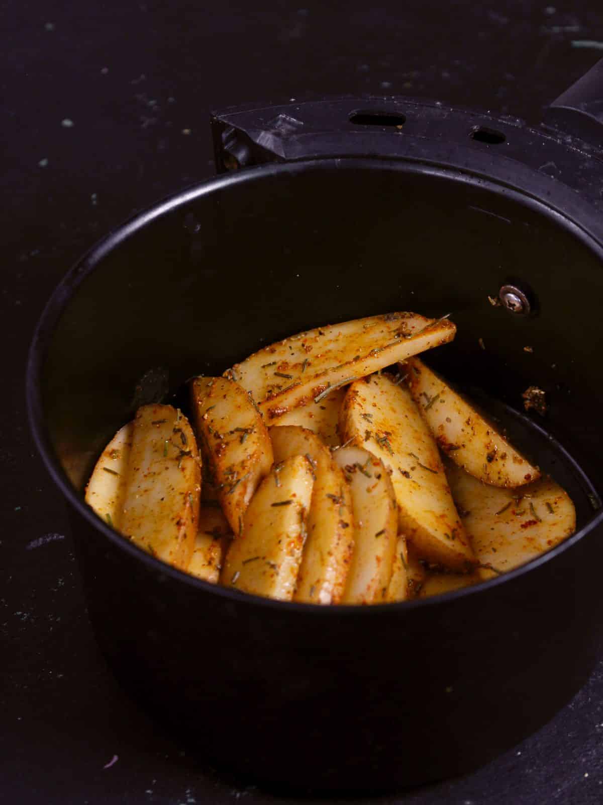 transfer the coated potato wedges into the air fryer 