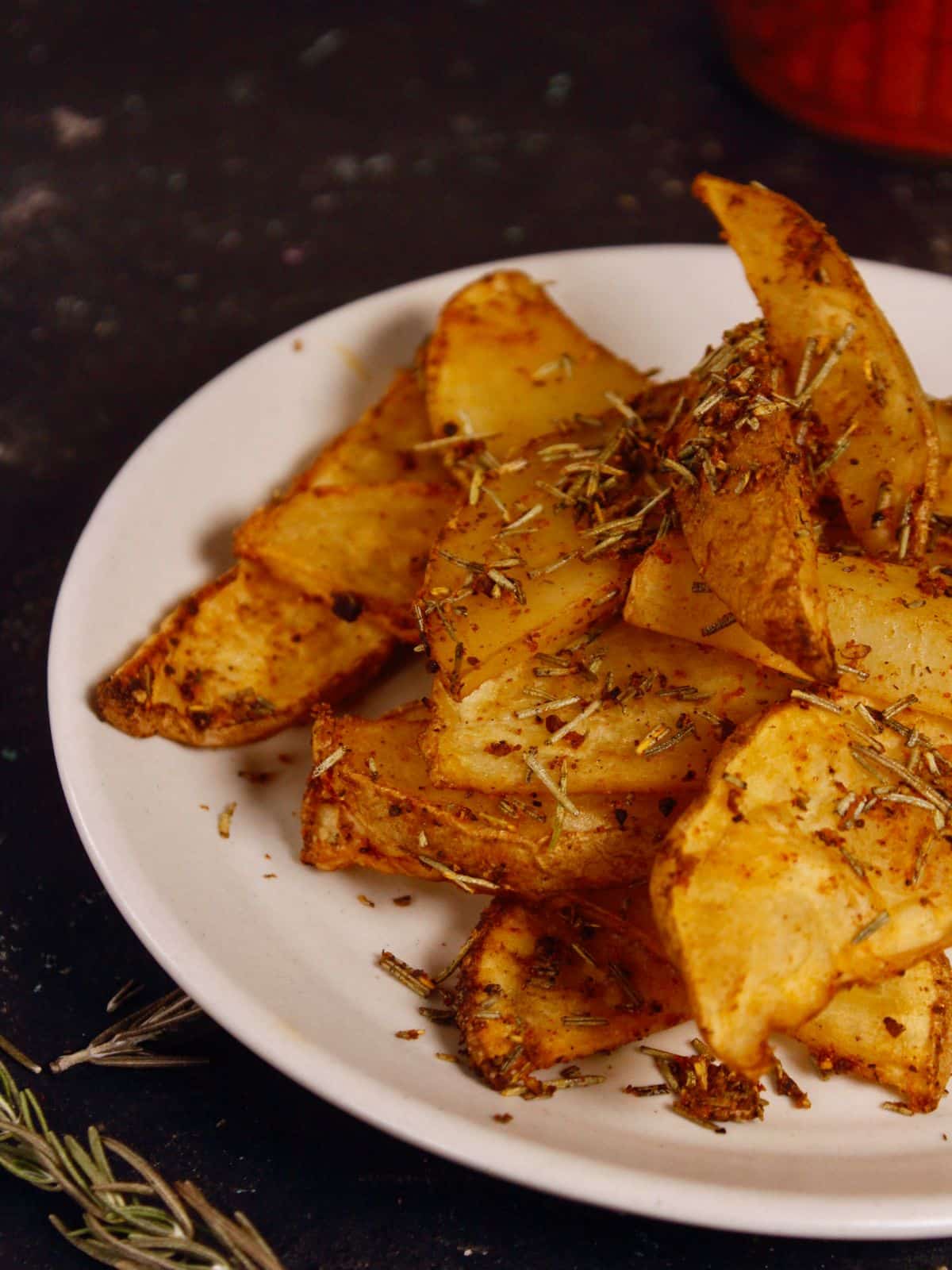left side view of air fried rosemary potato wedges