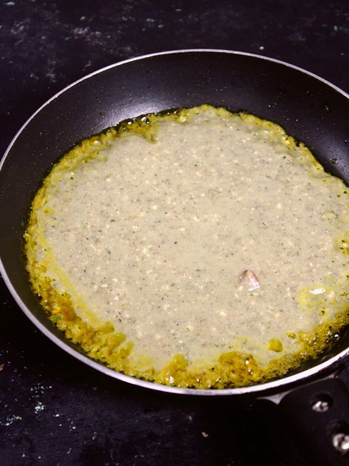 transfer the paste into the pan and cook on both the sides 