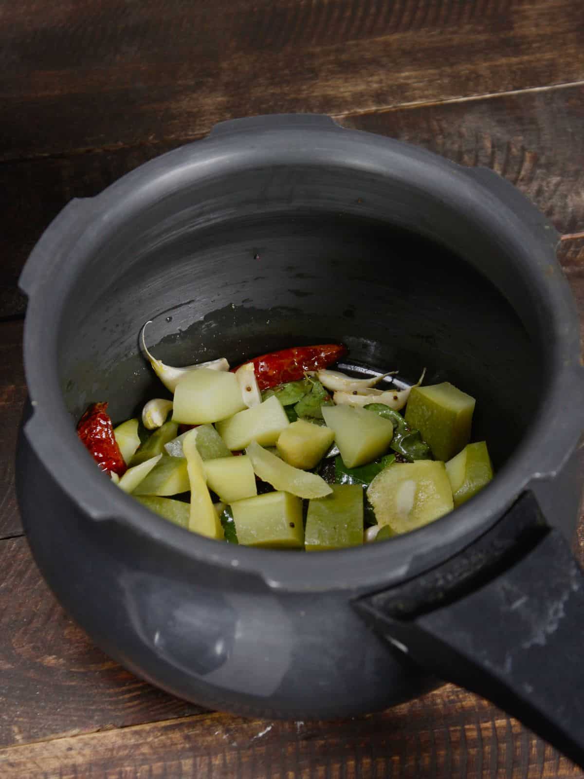 add chopped raw mangoes to the cooker 