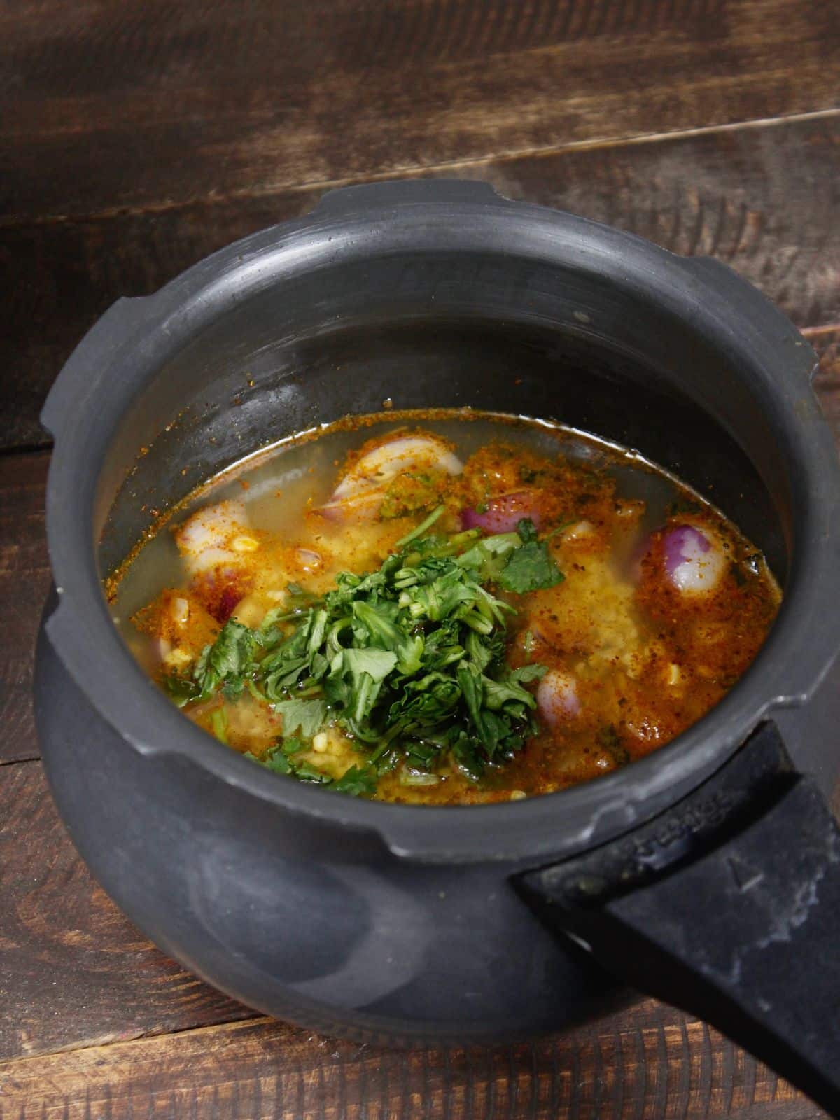 add chopped coriander leaves to the cooker and cook well 