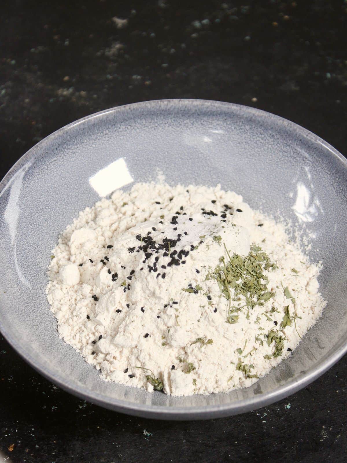 add flour along with all the seeds in a bowl 