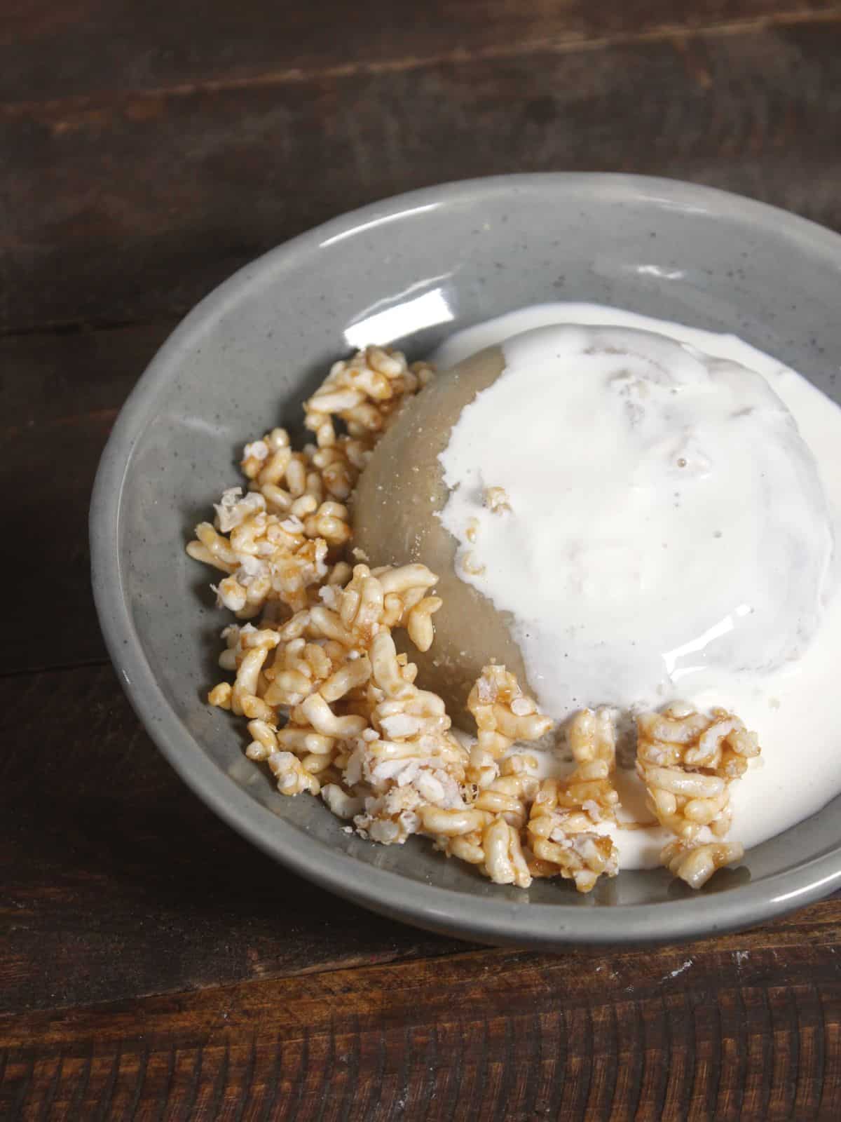 top the cake with cream and caramelized puffed rice 