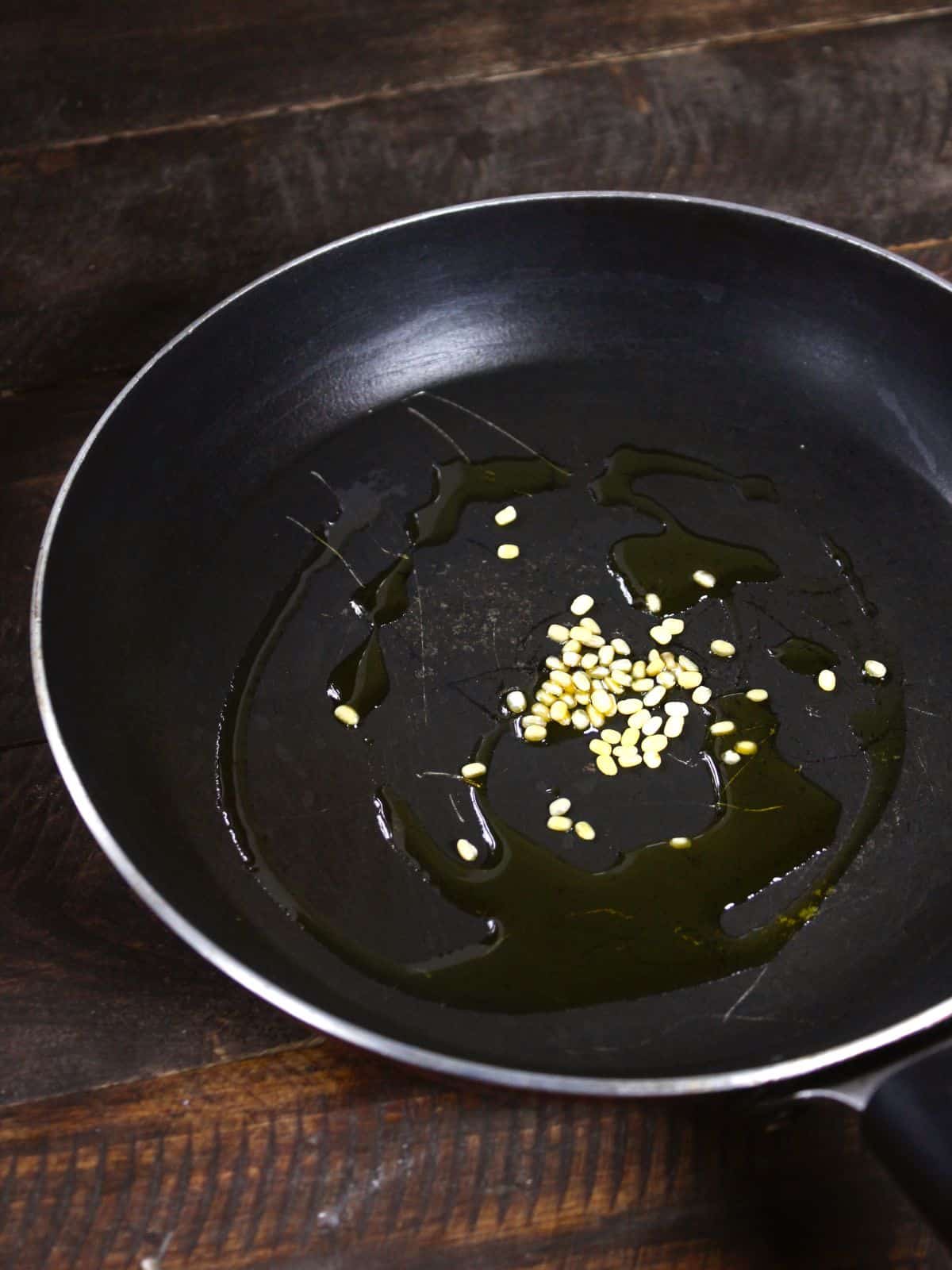 add green chilies and urad dal in a pan and saute 