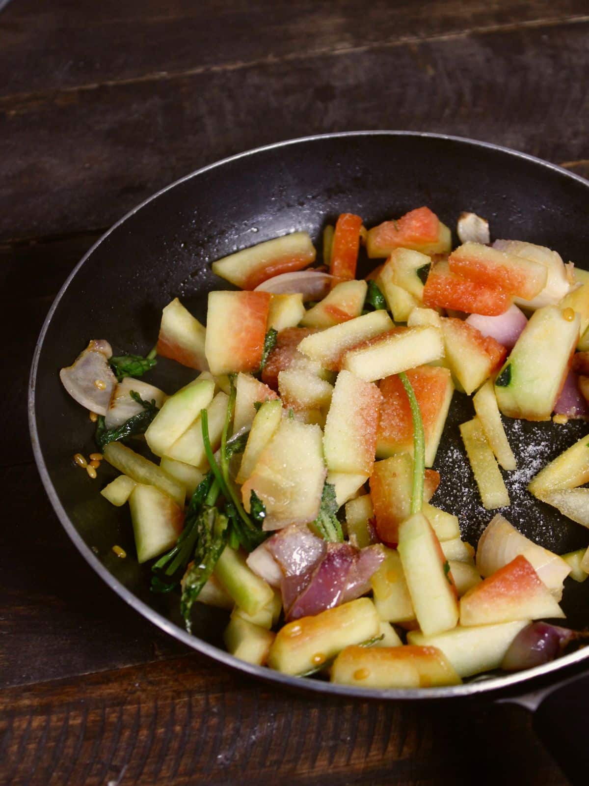 add salt and powdered spices to the pan and mix well