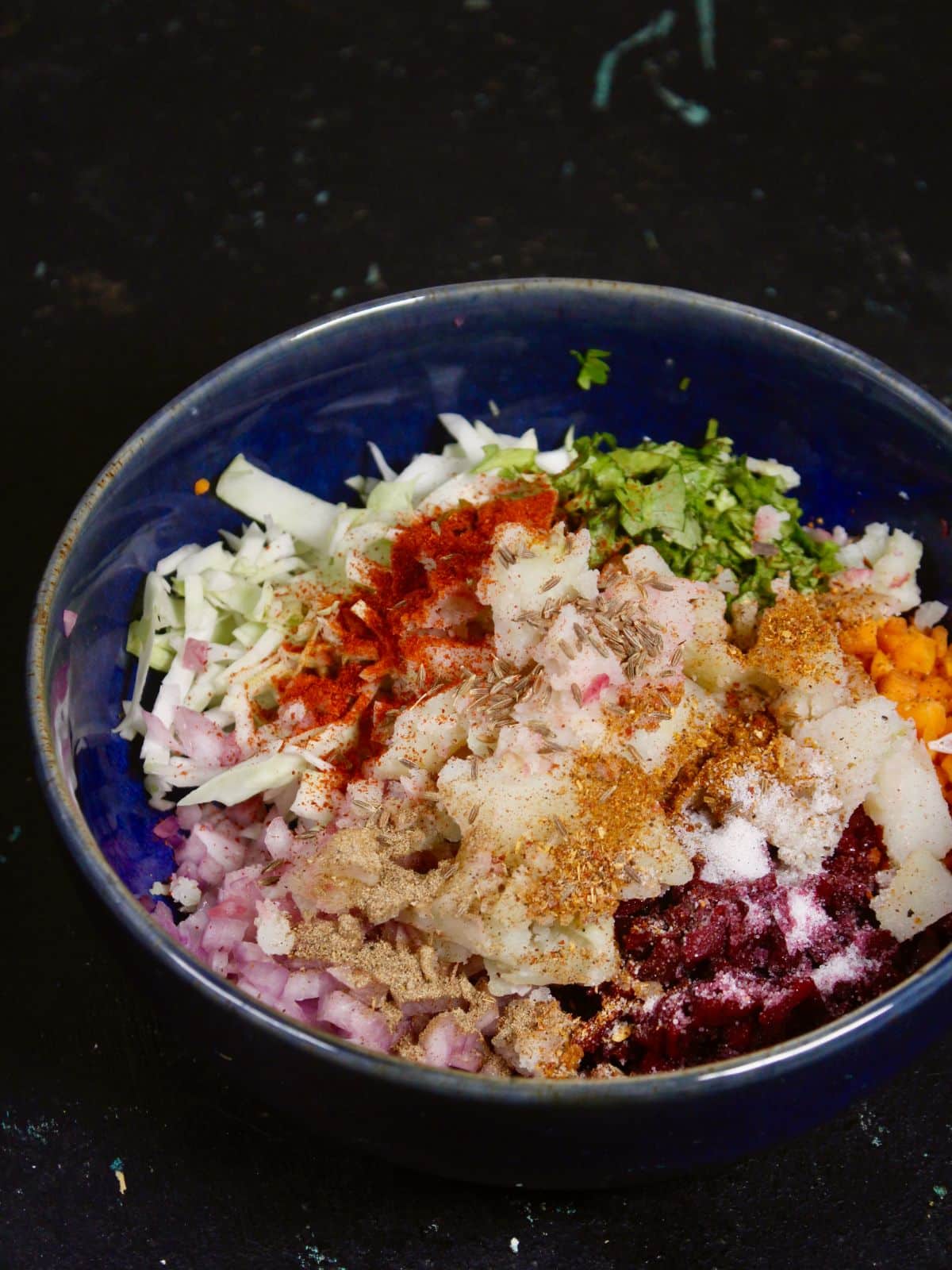 add all the chopped vegetables mix with all the powdered spices in a bowl 