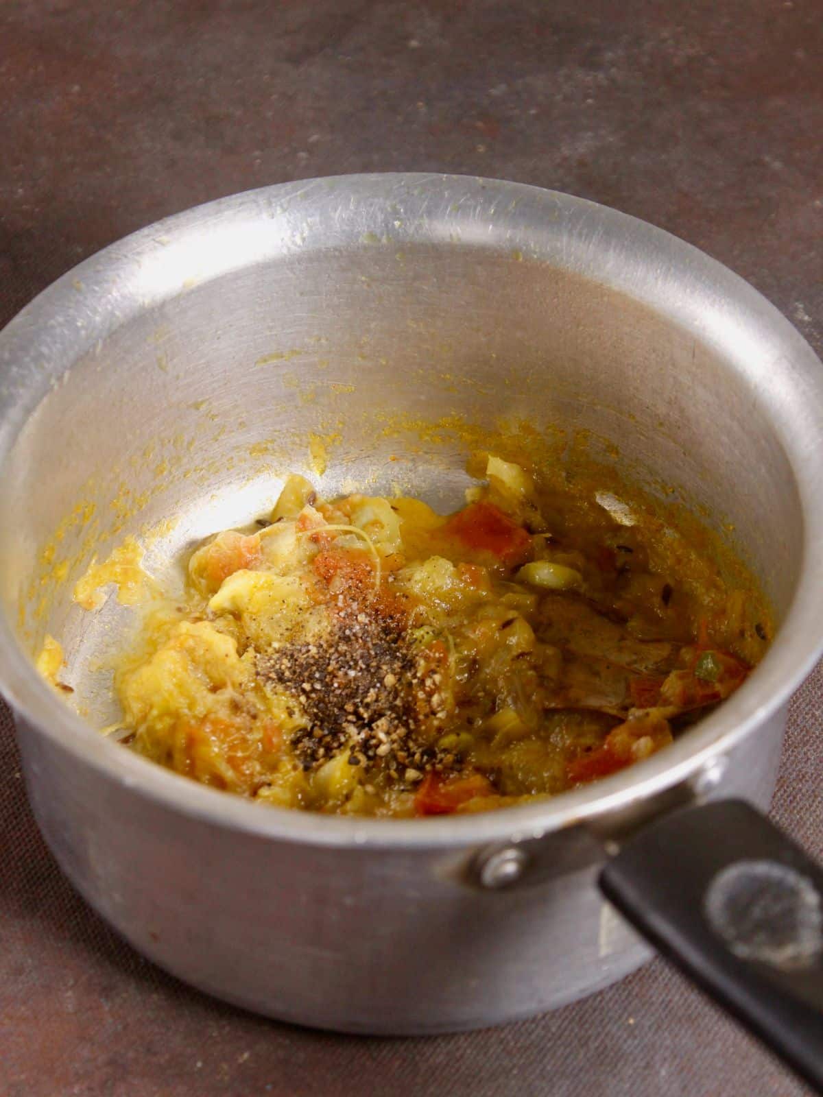 add powdered spices to the pot and mix well 