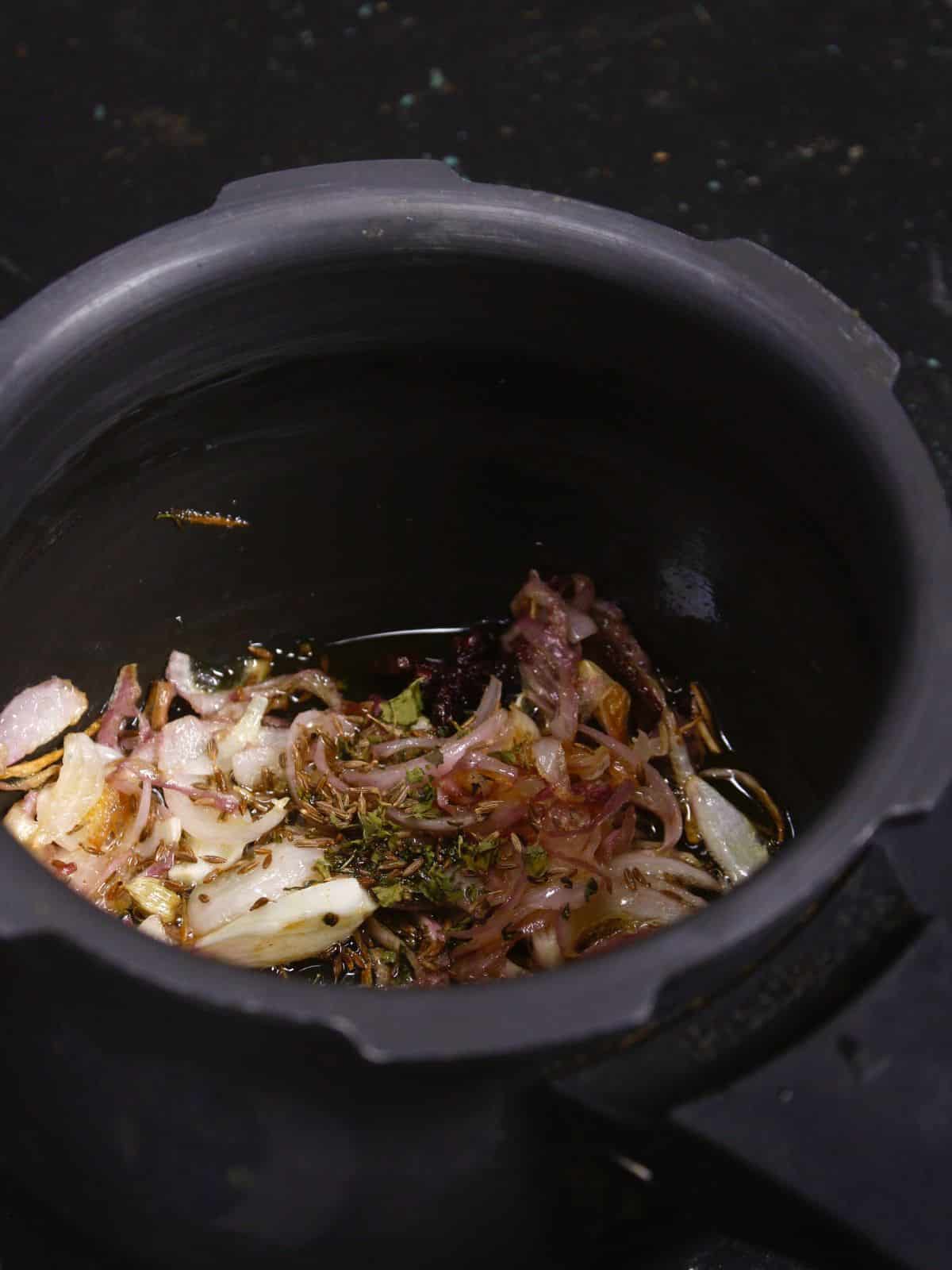 add cumin seeds and fenugreek seeds to the pot 