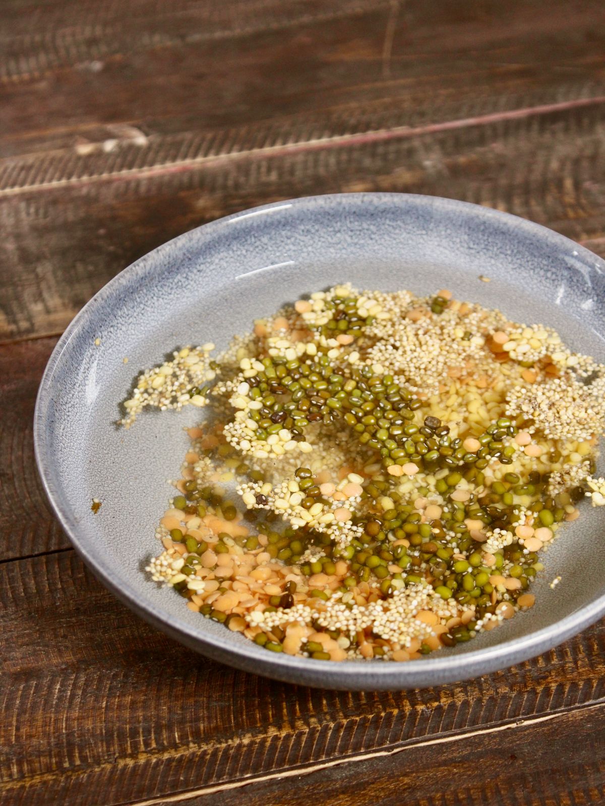 soak red, yellow and green lentils in a bowl 