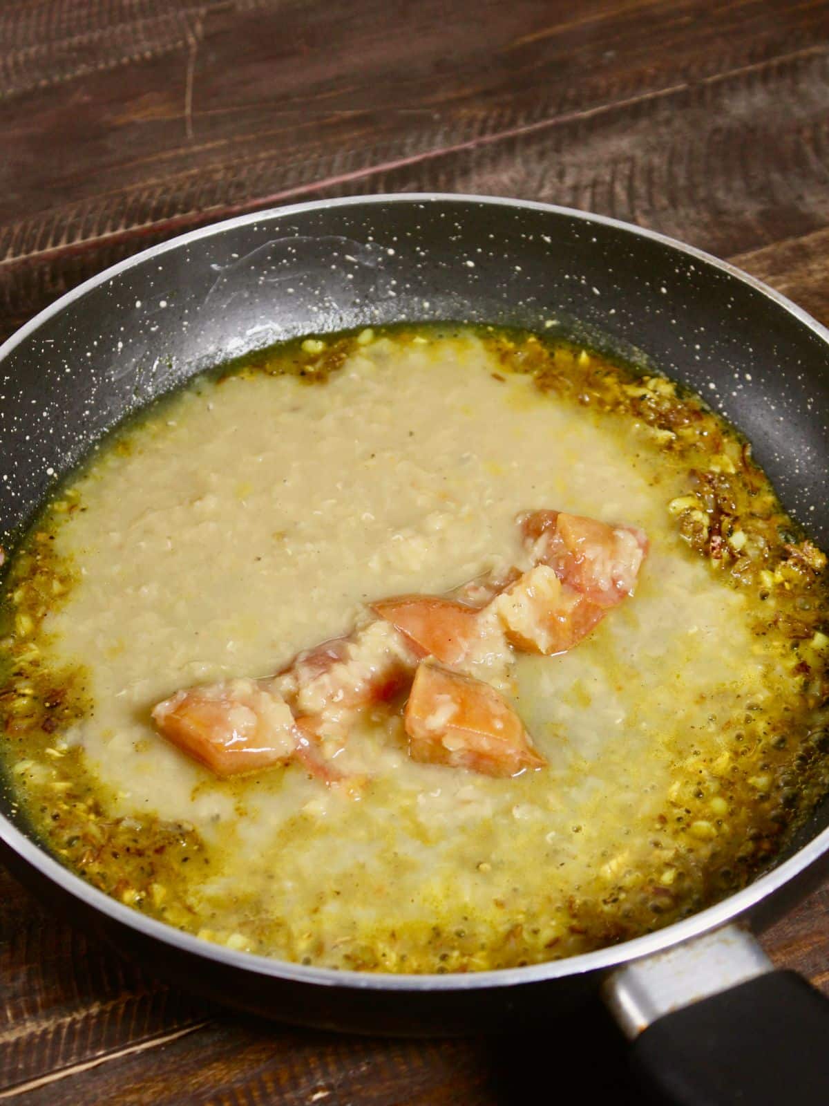 add soaked red lentils in the pan and mix well 