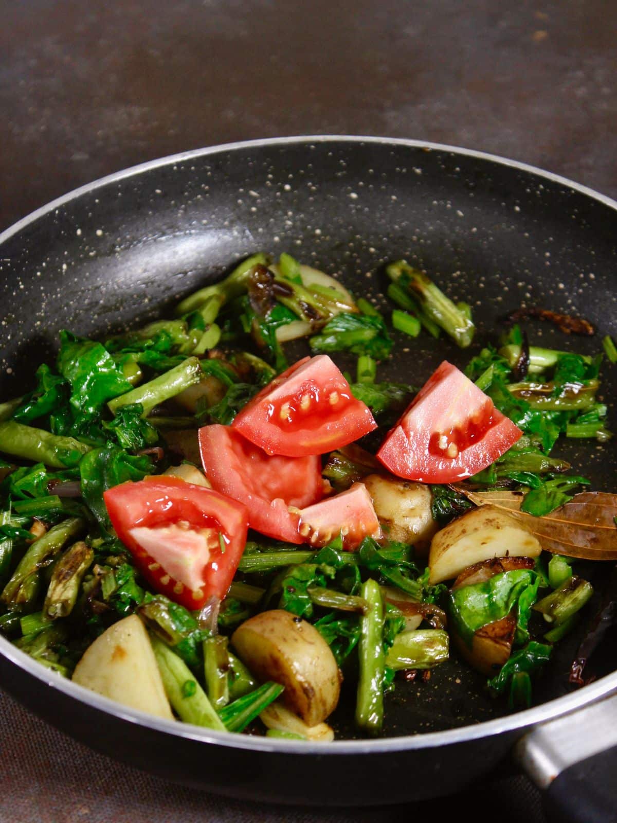 add tomato pieces to the pan and mix well 