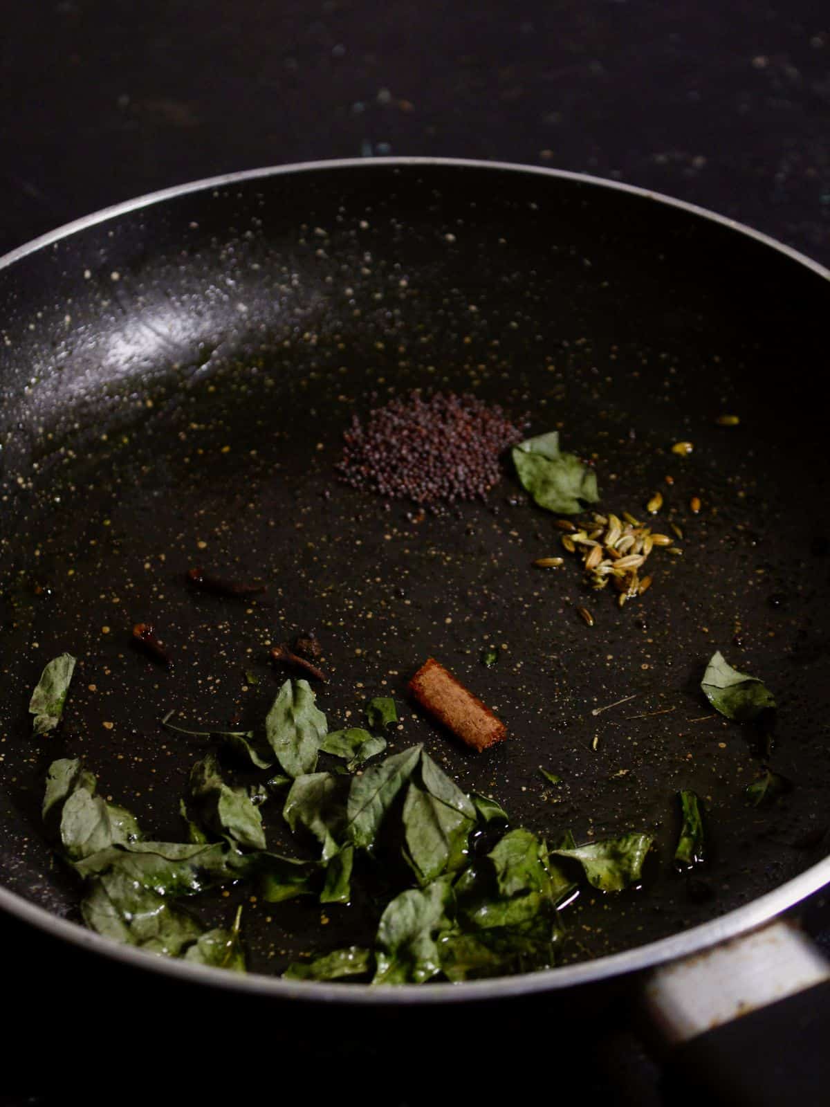 add seeds, leaves with oil and let them crackle 