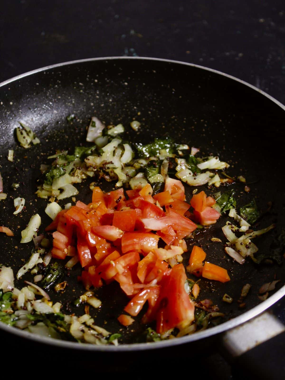 add chopped tomatoes to the pan and mix well 