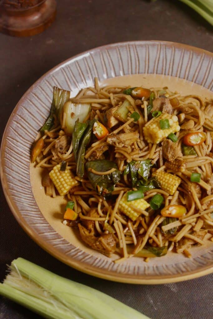 garnish hot Asian style whole wheat noodles with green chilies 