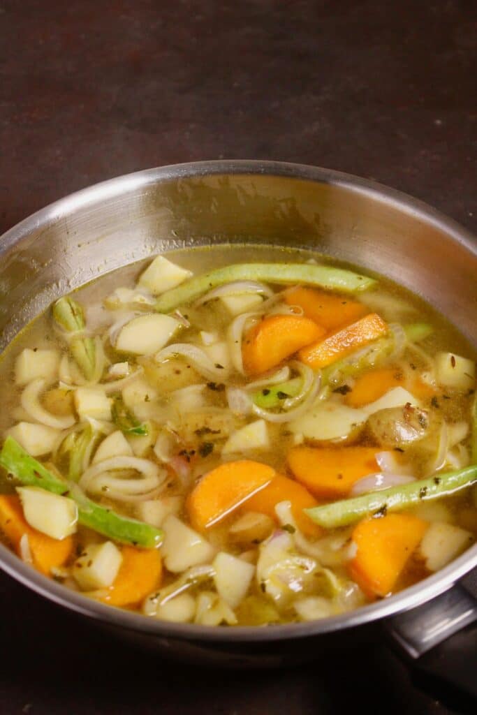add water and vegetable stock to the pan and cook 
