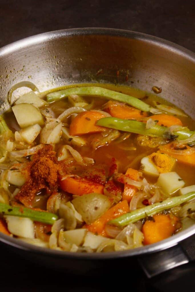 add powdered spices to the pan and mix well 