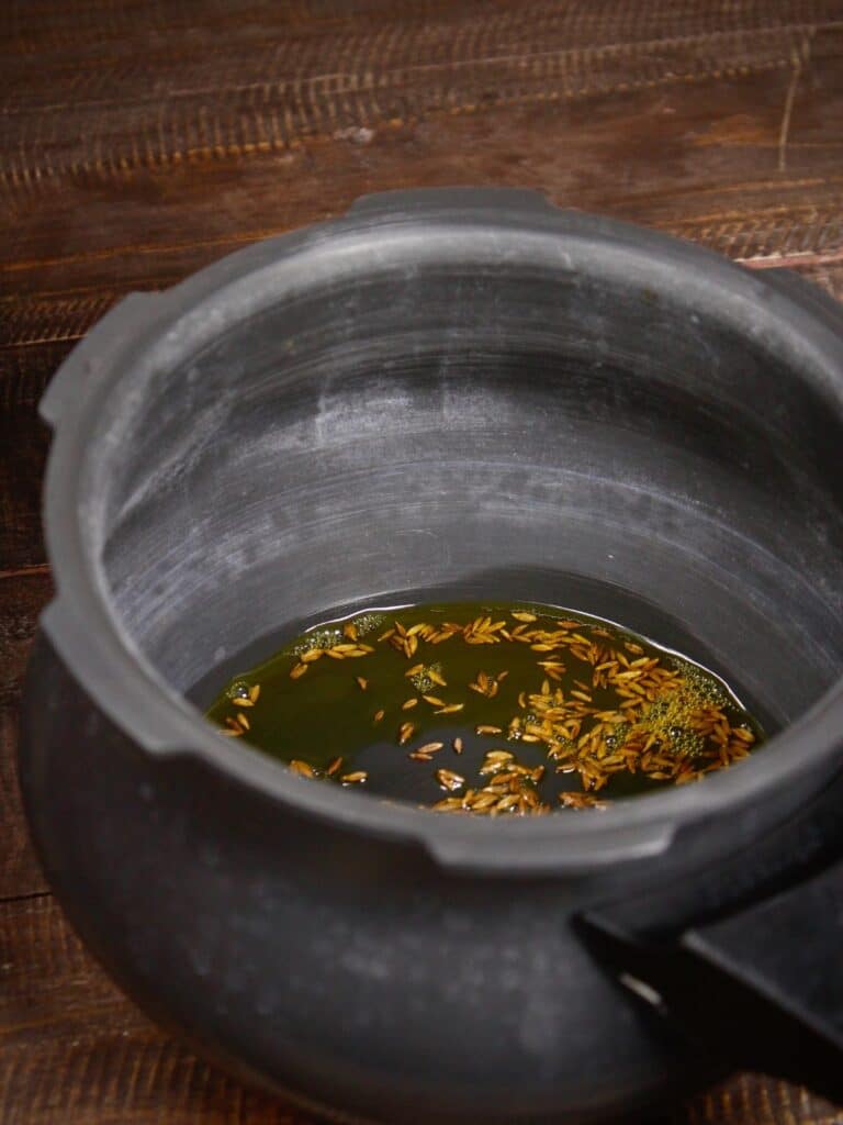 add cumin with oil in a pot
