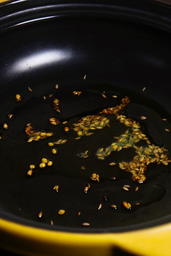 add cumin seeds with oil in a pan and let them crackle 