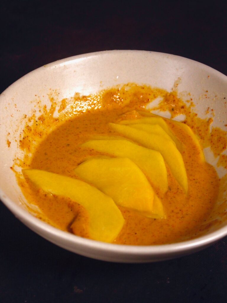 coat the pumpkin pieces into the mixture