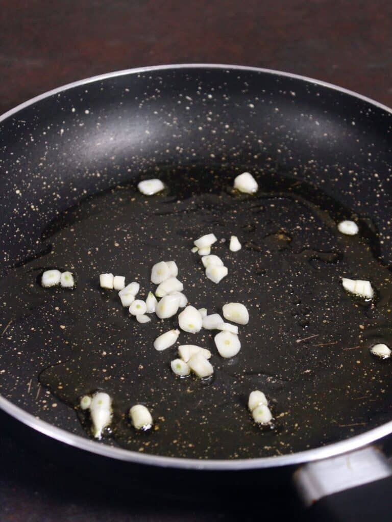 add oil and garlic in a pan 