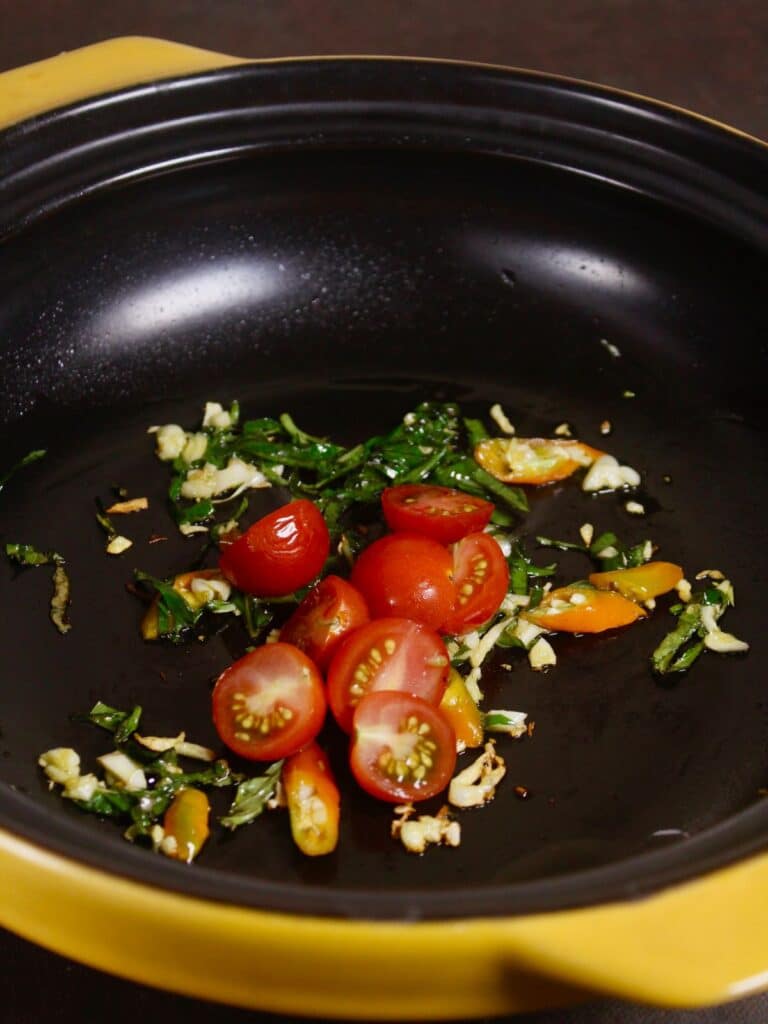 add halved tomatoes to the pan 